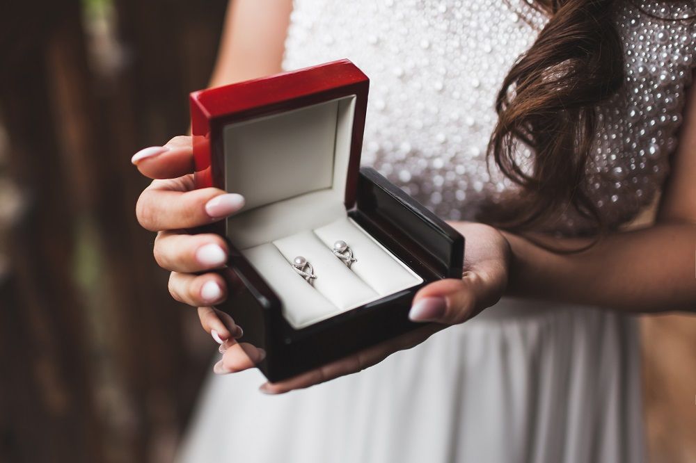 woman-holding-in-hands-box-with-pearl-earrings-get-ZPS6N7B.jpg