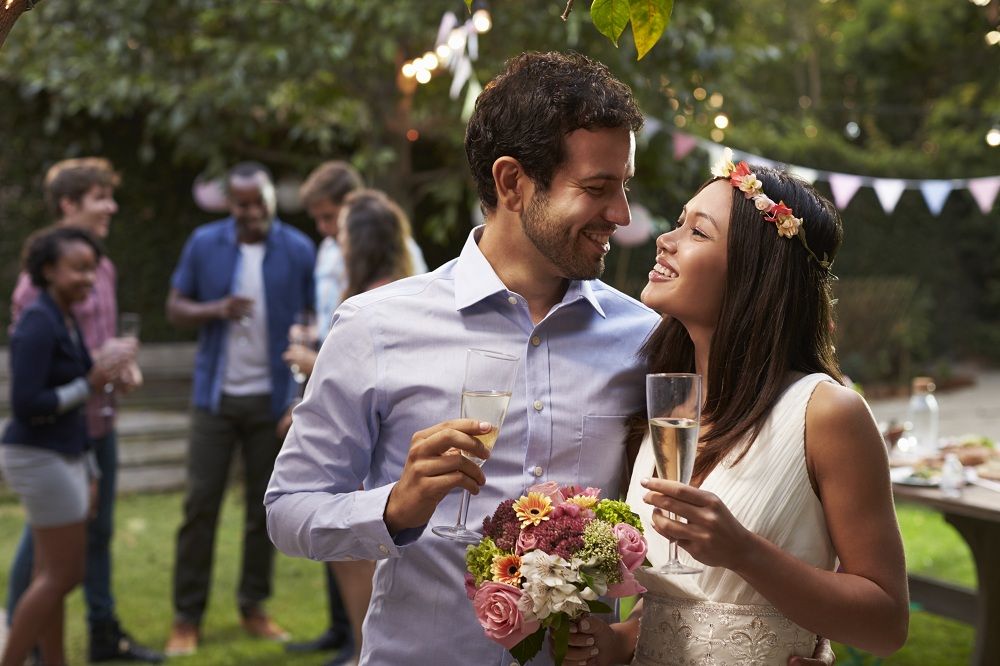 young-couple-celebrating-wedding-with-party-in-PPGWEDZ.jpg